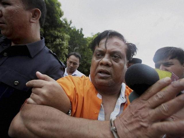 Indian fugitive Chhota Rajan is escorted by plain-clothed police officers for questioning in Bali, Indonesia, Tuesday, Nov. 3, 2015. Rajan may be brought to India on Wednesday. (AP) Indian fugitive Chhota Rajan is escorted by plain-clothed police officers for questioning in Bali, Indonesia, Tuesday, Nov. 3, 2015. Rajan may be brought to India on Wednesday. (AP)