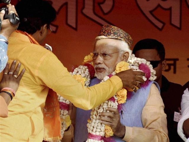 Prime Minister Narendra Modi garlanded during an election rally in Darbhanga on Monday. (PTI)