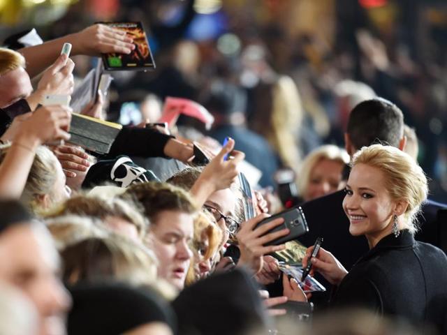 Jennifer Lawrence signs autopraphs for fans at the world premiere of The Hunger Games: Mockingjay — Part 2 in Berlin. (AFP)