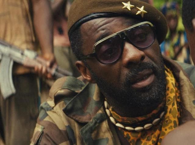 Fukunaga’s Beasts of No Nation focuses on the harrowing journey of a West African boy, Agu, as he is captured and brainwashed into a child soldier by Idris Elba’s merciless Commandant.(Photo courtesy: Netflix)