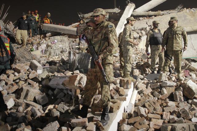 Pakistan army’s soldiers take part in rescue work following the collapse of a building in Lahore, Pakistan,. (AP Photo)