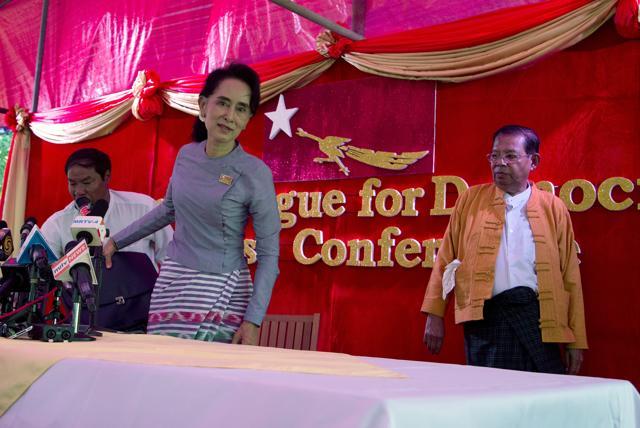 Myanmar's opposition leader Aung San Suu Kyi, centre, leaves a press conference at her home in Yangon, Myanmar. (AP Photo) Myanmar's opposition leader Aung San Suu Kyi, centre, leaves a press conference at her home in Yangon, Myanmar. (AP Photo)