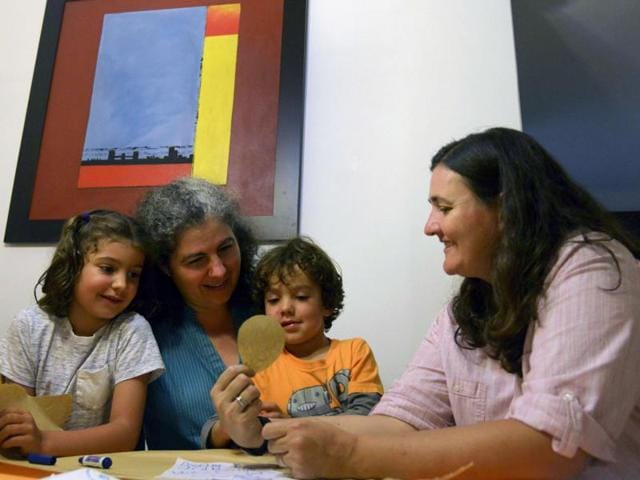 File photo of Colombian couple Ana Elisa Leiderman (L) and Veronica Botero (R) as they pose with their children Raquel (L), 6, and Ari, 4, both conceived by artificial insemination, at home in Medellin, Antioquia department, Colombia. Colombia's highest court ruled that same-sex couples can adopt children, lifting the last restriction on gays raising kids.(AFP Photo)