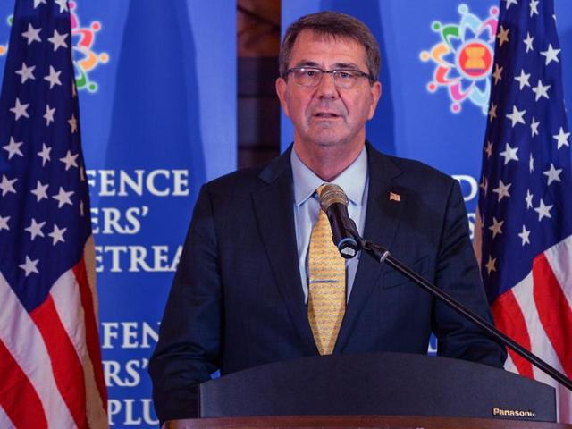 US Defence Secretary Ashton Carter (L) gestures as Malaysian military personnel carry remains recovered from a 1945 US military transport plane. Carter hit out at China over its disputed presence in the South China Seas in a visit to the region on Thursday. (AFP Photo) US Defence Secretary Ashton Carter (L) gestures as Malaysian military personnel carry remains recovered from a 1945 US military transport plane. Carter hit out at China over its disputed presence in the South China Seas in a visit to the region on Thursday. (AFP Photo)