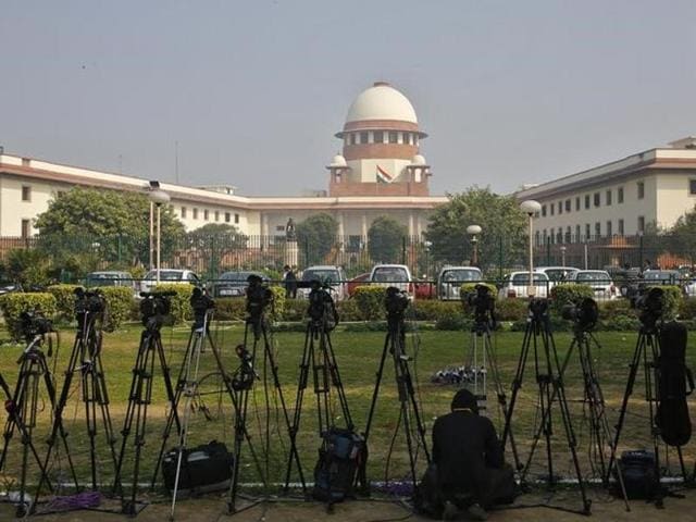 A television journalist sets his camera inside the premises of the Supreme Court in New Delhi. (Reuters) A television journalist sets his camera inside the premises of the Supreme Court in New Delhi. (Reuters)