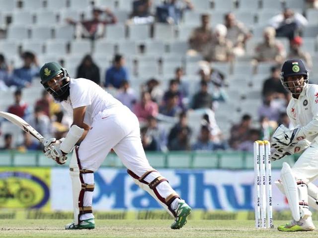 Right-handed batsman Hashim Amla  and Indian wicketkeeper Wriddhiman Saha watch a shot. (Gurpreet Singh /HT Photo ) 