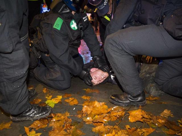 British police officers detain a protester during the "Million Masks March", organised by the anti-capitalist group Anonymous, in Trafalgar Square in London. (AFP) British police officers detain a protester during the "Million Masks March", organised by the anti-capitalist group Anonymous, in Trafalgar Square in London. (AFP)