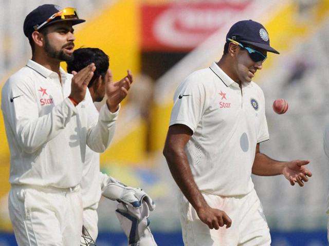 India's Ravichandran Ashwin, who took five wickets, walks off the pitch as skipper Virat Kohli applauds. (PTI Photo) 