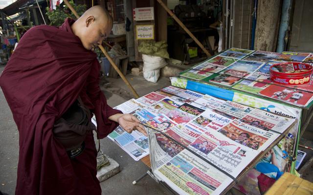 A Buddhist monk reads newspapers featuring Myanmar opposition leader Aung San Suu Kyi on the cover in Yangon, Myanmar. (AP) A Buddhist monk reads newspapers featuring Myanmar opposition leader Aung San Suu Kyi on the cover in Yangon, Myanmar. (AP)
