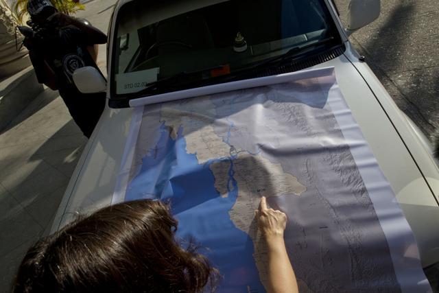 A short-term election observer of the European Union Election Observation Mission to Myanmar (EU EOM) points a place on a map ahead of deployment in Yangon. (AP) A short-term election observer of the European Union Election Observation Mission to Myanmar (EU EOM) points a place on a map ahead of deployment in Yangon. (AP)
