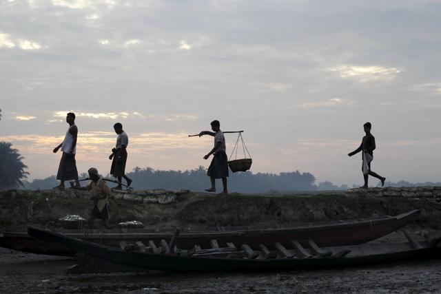 Muslim Rohingya fishermen walk by the port at a refugee camp outside Sittwe October 29, 2015. As Myanmar heads to the polls on Nov. 8 the plight of its Muslim minority remains a blot on what is billed as the country's first free and fair election for 25 years. (REUTERS) Muslim Rohingya fishermen walk by the port at a refugee camp outside Sittwe October 29, 2015. As Myanmar heads to the polls on Nov. 8 the plight of its Muslim minority remains a blot on what is billed as the country's first free and fair election for 25 years. (REUTERS)