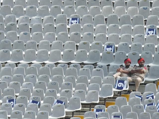 Punjab Police officials on duty sit in empty stands at the PCA Stadium. (Gurpreet Singh/HT Photo) 