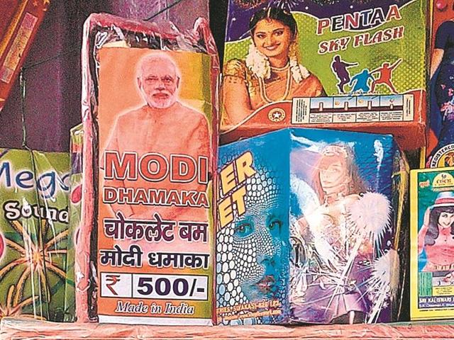 Party workers and supporters of the BJP-led NDA, confident of victory on Sunday, are leading the way in purchasing anything with the Modi name on it – from Modi rockets and bombs to Modi chakris and phuljharis (sparklers).(HT Photo) Party workers and supporters of the BJP-led NDA, confident of victory on Sunday, are leading the way in purchasing anything with the Modi name on it – from Modi rockets and bombs to Modi chakris and phuljharis (sparklers).(HT Photo)