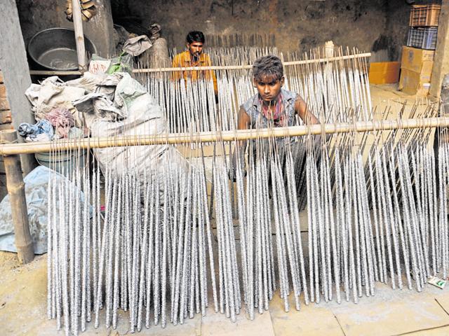 Workers make firecrackers at one of the small fireworks’ manufacturing units at Farrukhnagar-Asalatpur village near Ghaziabad. (Sakib Ali/HT Photo)
