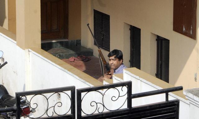 A forest department official, equipped with a tranquillizer gun, looks for the panther. (Himanshu Vyas/HT Photo)