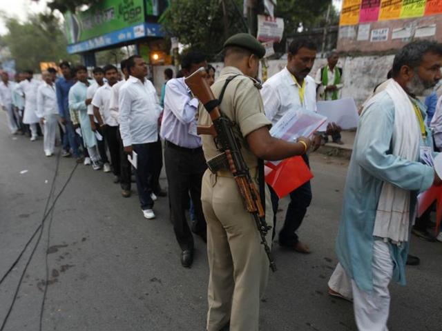 Security personnel check documents of poll observers at a vote counting centre in Patna. (Ajay aggarwal/ht photo)