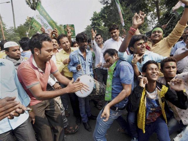 Supporters dance as they celebrate the Grand Alliance's victory in Bihar assembly elections in Patna on Sunday. (PTI)