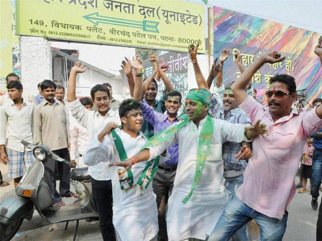 JD(U) supporters dance as they celebrate victory in Bihar assembly elections outside the party office in Patna on Sunday. (PTI)