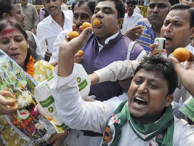 Supporters of the Grand Alliance celebrate at CM Nitish Kumar’s residence on the vote counting day of the Bihar Assembly elections, in Patna. (AP Dube/ HT Photo)
