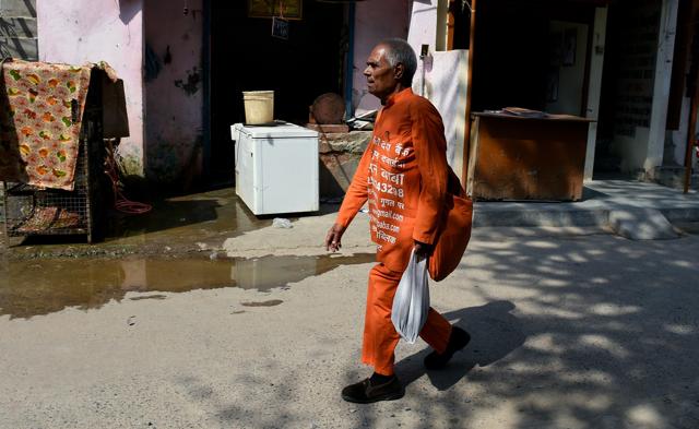 In his trademark bright orange smock, Sharma cuts a familiar figure in Delhi’s leafy neighbourhoods, and residents routinely carry out handfuls of medicines for him. (AFP Photo) In his trademark bright orange smock, Sharma cuts a familiar figure in Delhi’s leafy neighbourhoods, and residents routinely carry out handfuls of medicines for him. (AFP Photo)