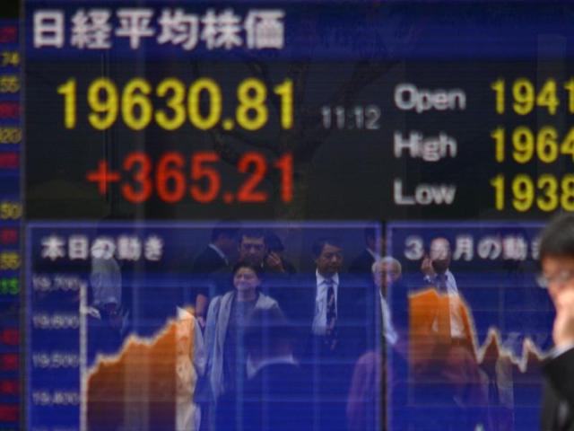 A pedestrian looks at a share prices board in Tokyo. G20 leaders will meet this month to discuss the global financial crisis. (AFP) A pedestrian looks at a share prices board in Tokyo. G20 leaders will meet this month to discuss the global financial crisis. (AFP)