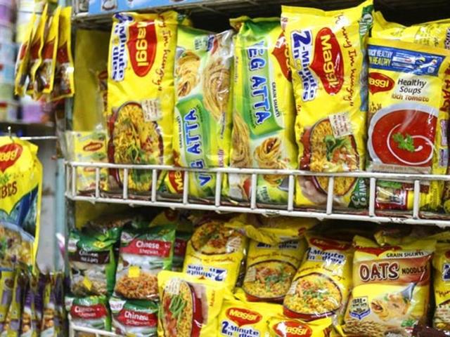 A file photo of a shopkeeper in Delhi holding packets of Maggi noodles.(Raj K Raj/HT Photo)