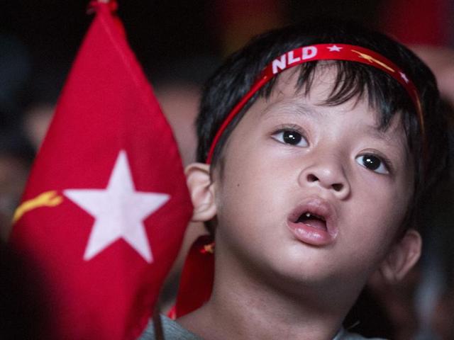A young supporter of Myanmar's National League for Democracy party cheers as election results are posted outside the NLD headquarters in Yangon. (AP Photo)