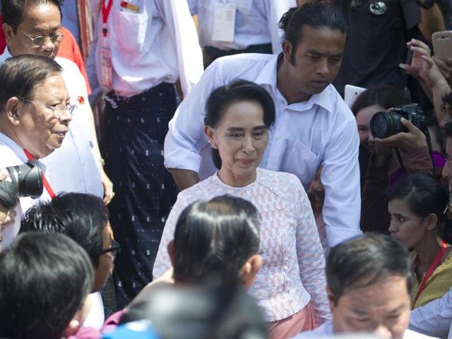 Myanmar opposition leader Aung San Suu Kyi leaves the headquarters of the National League of Democracy (NLD) after addressing a small crowd and the media. (AFP Photo)