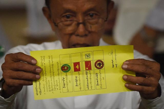 In this photo taken on November 8, 2015, a poll official displays a ballot marked for the candidate of Myanmar opposition leader Aung San Suu Kyi's National League for Democracy (NLD) during poll tabulation in Yangon. (AFP) In this photo taken on November 8, 2015, a poll official displays a ballot marked for the candidate of Myanmar opposition leader Aung San Suu Kyi's National League for Democracy (NLD) during poll tabulation in Yangon. (AFP)