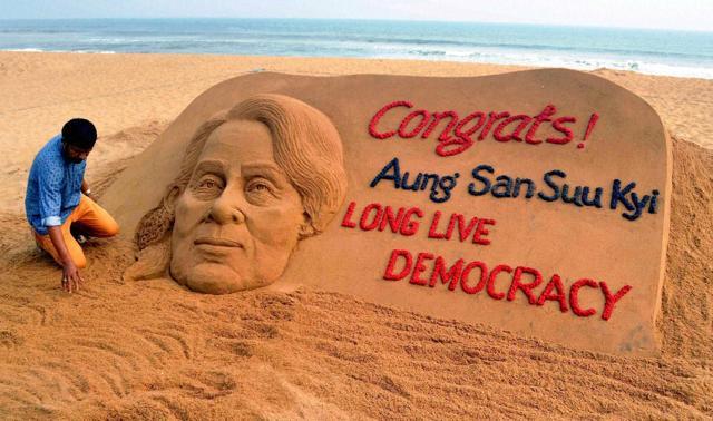 Sand artist Sudarshan Pattnaik creates a sand sculpture with a message Congrats! Aung San Suu Kyi, Long Live Democracy at Puri beach of Odisha on Monday. (PTI) Sand artist Sudarshan Pattnaik creates a sand sculpture with a message Congrats! Aung San Suu Kyi, Long Live Democracy at Puri beach of Odisha on Monday. (PTI)
