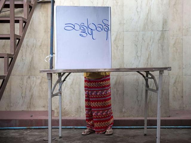 A Muslim Myanmar voter casts her vote at a polling station in Yangon on Sunday. (AFP Photo)