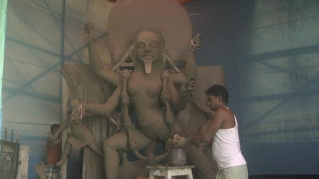 A man decorates the idol of Goddess Kali at a temple in Kendua village. (HT Photo) A man decorates the idol of Goddess Kali at a temple in Kendua village. (HT Photo)