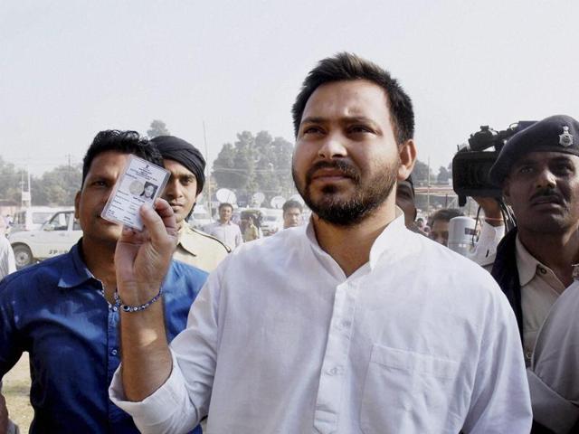 RJD leader Tejashwi Yadav shows his voter card at a polling station during third phase of Bihar assembly elections in Patna. (PTI Photo) RJD leader Tejashwi Yadav shows his voter card at a polling station during third phase of Bihar assembly elections in Patna. (PTI Photo)