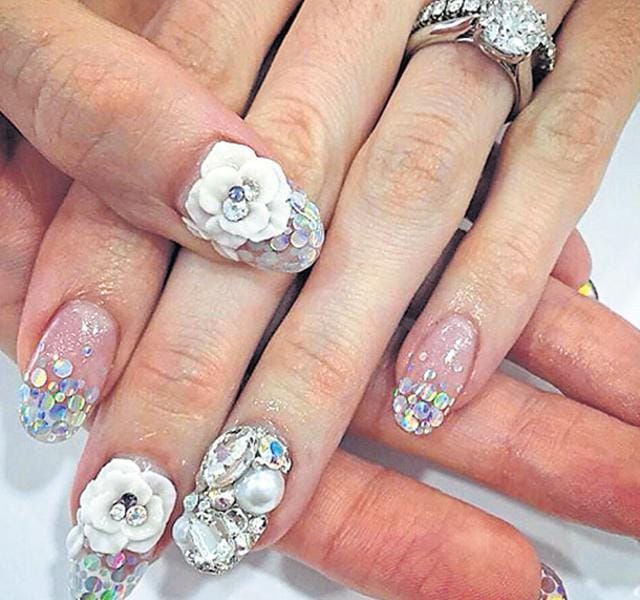 Choose tiny plastic flowers in various shapes. Place them on wet glitter nailpaint. Secure it with top coat. Choose tiny plastic flowers in various shapes. Place them on wet glitter nailpaint. Secure it with top coat.