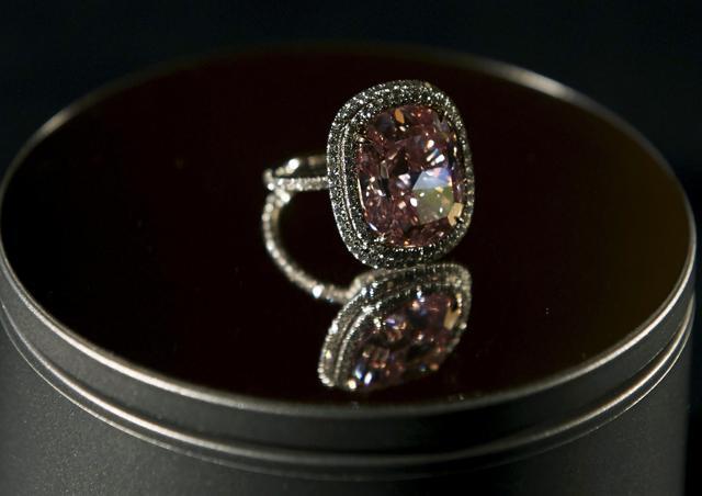 The cushion-shaped diamond, set in a ring and rounded with a double row of smaller white diamonds, was the showcase piece in the 409-lot sale of jewelry. (REUTERS) The cushion-shaped diamond, set in a ring and rounded with a double row of smaller white diamonds, was the showcase piece in the 409-lot sale of jewelry. (REUTERS)