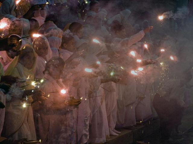 Widows hold sparklers and deepas -- oil lamps -- during Diwali celebrations at Kesi Ghat on the banks of the Yamuna river in Vrindavan . (AFP)