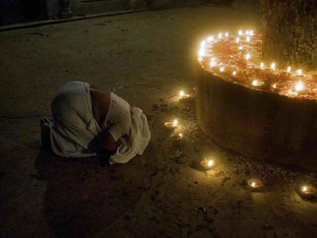 A widow prays before a sacred tree during Diwali celebrations at the Meera Sahabhagini Widows Ashram in Vrindavan. (AFP)