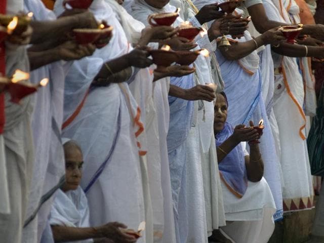 Widows hold lit deepas -- oil lamps -- during Diwali celebrations at Kesi Ghat on the banks of the Yamuna river in Vrindavan. (AFP)