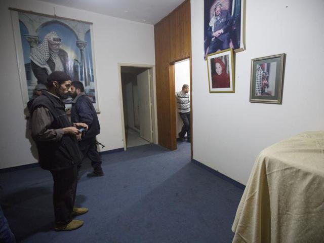 Palestinians take photos of the clothes of former Palestinian president Yasser Arafat, in the bedroom of his house. (AP) Palestinians take photos of the clothes of former Palestinian president Yasser Arafat, in the bedroom of his house. (AP)