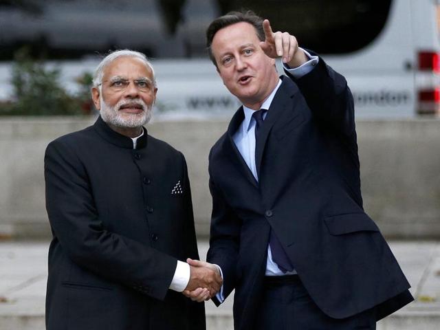 Britain's Prime Minister David Cameron and India's Prime Minister Narendra Modi watch a flypast by the Royal Air Force Red Arrows display team in Parliament square in London.(AFP)