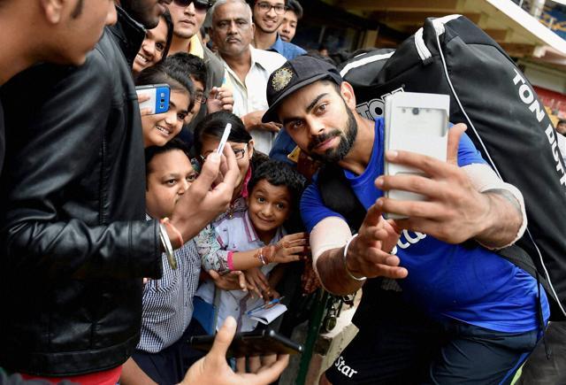 Skipper Virat Kohli taking selfie with fans during a practice session ahead of the 2nd test match against South Africa at Chinnaswamy Stadium in Bengaluru on Thursday. (PTI) Skipper Virat Kohli taking selfie with fans during a practice session ahead of the 2nd test match against South Africa at Chinnaswamy Stadium in Bengaluru on Thursday. (PTI)