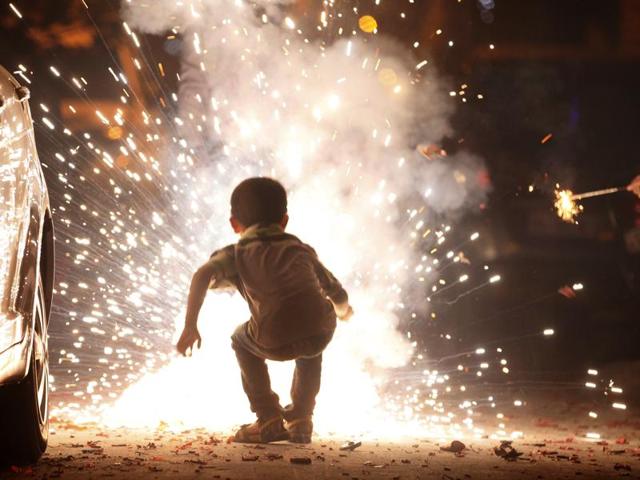 People burst crackers as they celebrate Diwali festival on Wednesday night, in New Delhi. . (Raj K Raj/ HT Photo) People burst crackers as they celebrate Diwali festival on Wednesday night, in New Delhi. . (Raj K Raj/ HT Photo)