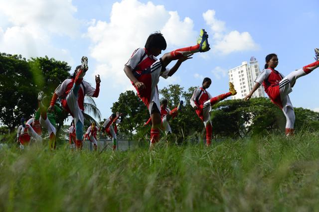 In this photograph taken on September 14, 2015, young Bangladeshi girls from Kolsindur high school football team stretch before a match in Dhaka. (AFP Photo) In this photograph taken on September 14, 2015, young Bangladeshi girls from Kolsindur high school football team stretch before a match in Dhaka. (AFP Photo)