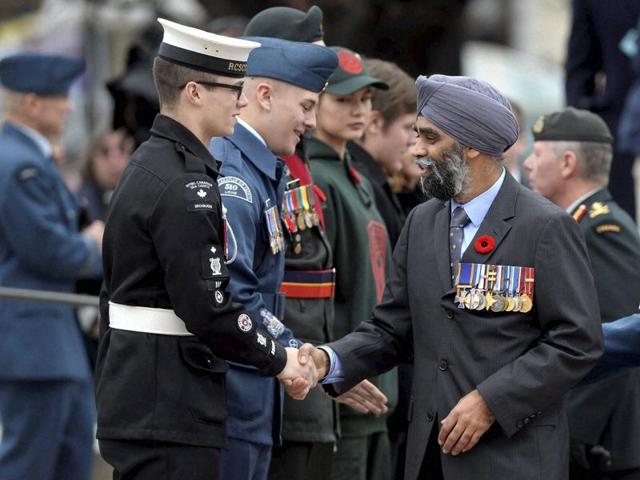 Defense Minister Harjit Singh Sajjan shakes hands with a cadet during the Remembrance Day ceremony in Ottawa on Wednesday. (AP) Defense Minister Harjit Singh Sajjan shakes hands with a cadet during the Remembrance Day ceremony in Ottawa on Wednesday. (AP)