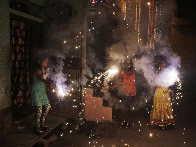 Chjldren play with firecrackers during Diwali celebrations in New Delhi. (AP)