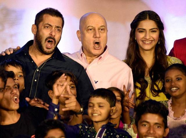 Salman Khan, Sonam Kapoor and Anupam Kher along with Dharavi Rocks, a band of kids who make music out of waste materials during a promotional event for Prem Ratan Dhan Payo in Mumbai on Wednesday. (PTI)