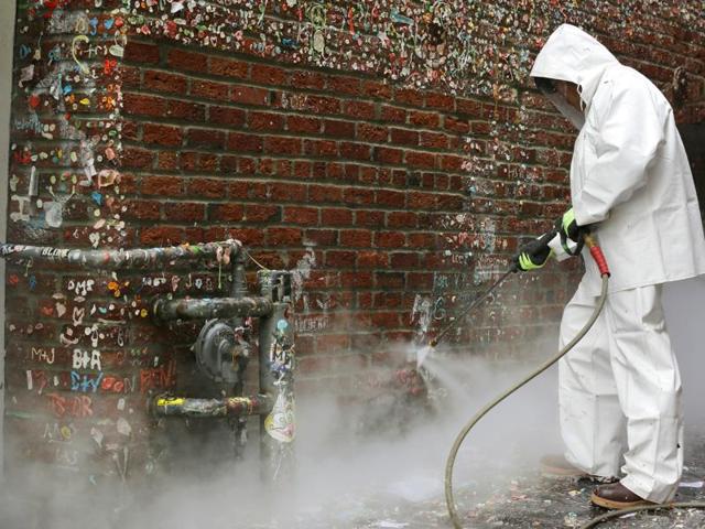 The wall is covered with a layer of gum which is several inches thick. Though the authorities are cleaning the wall, officials expect the gum-sticking tradition to return soon. (AP)