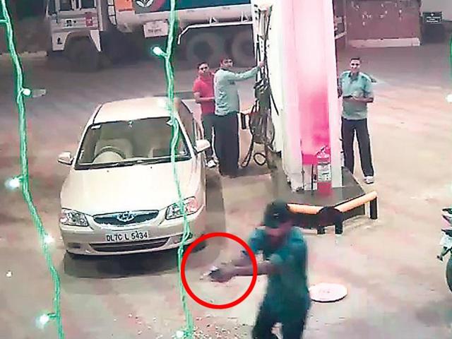 A grab from the footage recorded by the CCTV installed at the petrol filling stations shows an assailant with a gun. A grab from the footage recorded by the CCTV installed at the petrol filling stations shows an assailant with a gun.