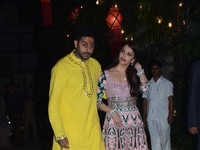 Aishwarya Rai Bachchan and Abhishek Bachchan welcome guests at Amitabh Bachchan`s Diwali party in Mumbai on Nov 11, 2015. (IANS)