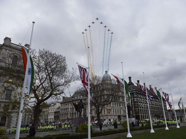 The Royal Air Force Aerobatic Team, the Red Arrows, conduct a flypast over the Houses of Parliament in central London on November 12, 2015 during the visit of Indian Prime Minister Narendra Modi. (AFP)